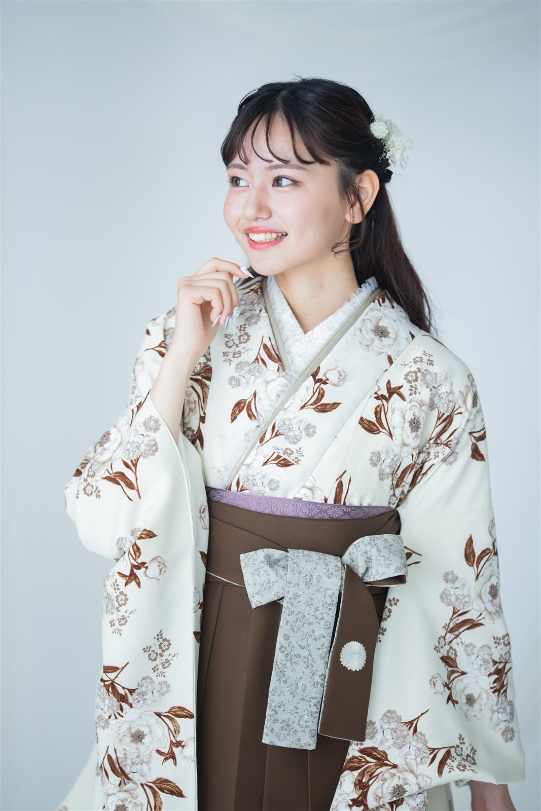 こげ茶の袴に、生成り地の小花柄の着物を合わせた卒業式の装い